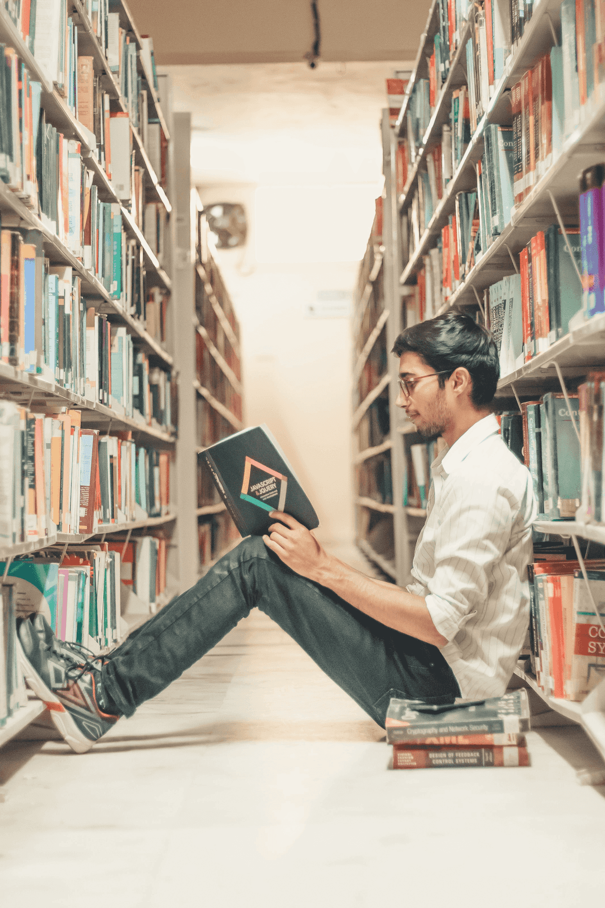 Person reading a book in a library